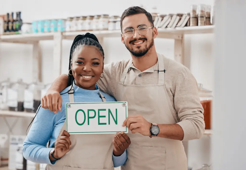 Franchise owners with an open sign