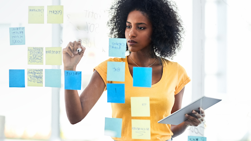 A woman at a board with post-it notes