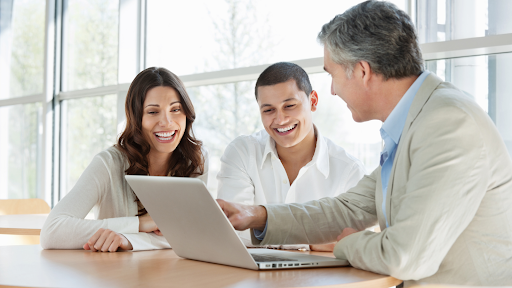A man and woman looking at a laptop
