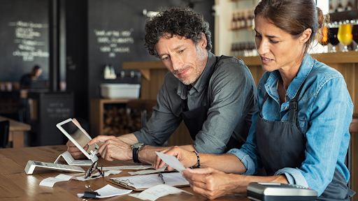 Man and women looking at bills.