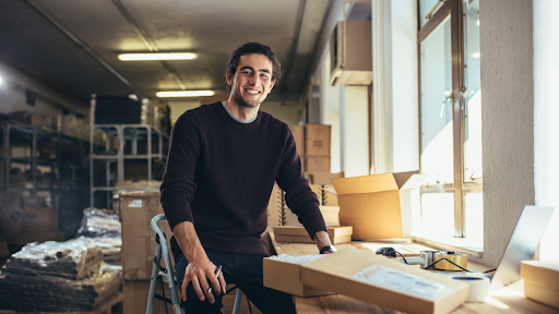 Man posing with boxes